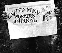 A small boy holding a union newspaper near the beginning of the coal strike in 1912.  Cumberland Museum and Archives, C110-128.